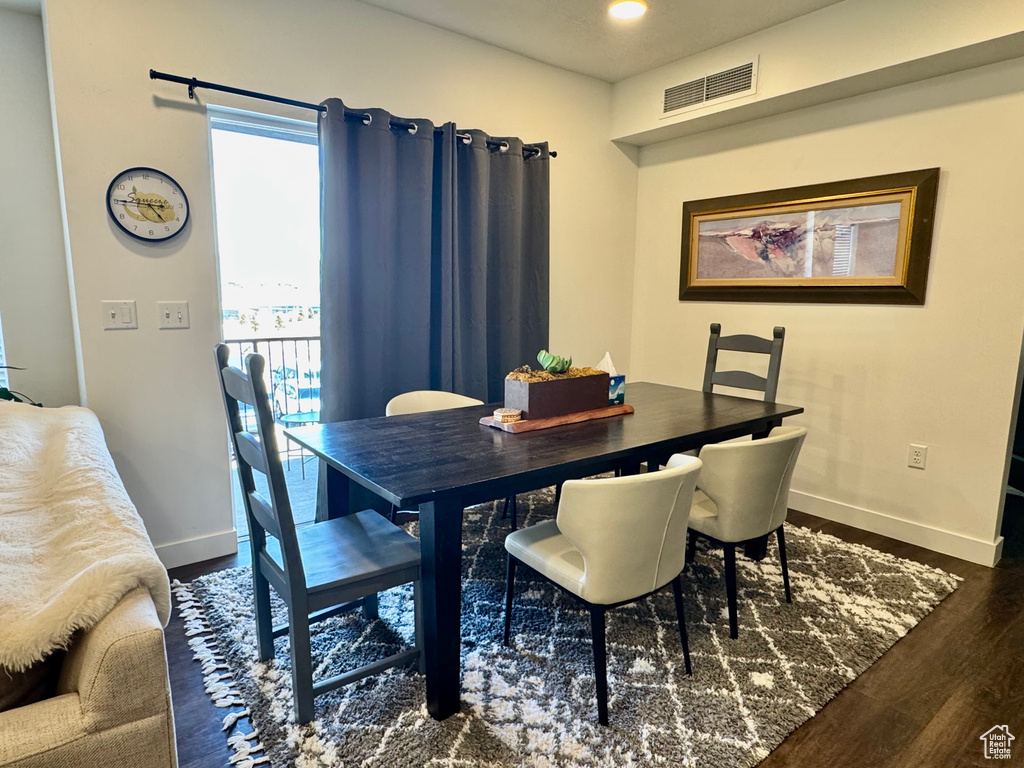 Dining area featuring baseboards, visible vents, and wood finished floors