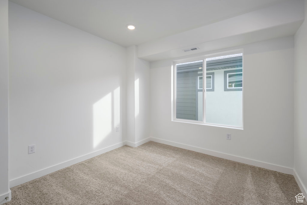Carpeted empty room with recessed lighting, baseboards, and visible vents