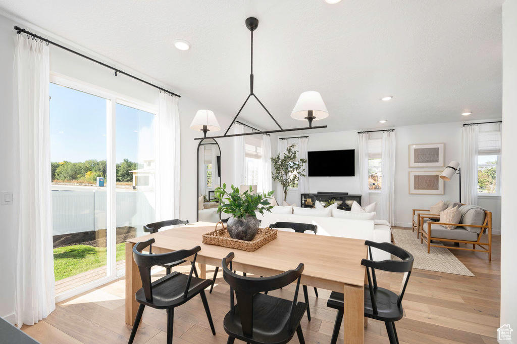 Dining area featuring recessed lighting, a notable chandelier, and light wood-type flooring
