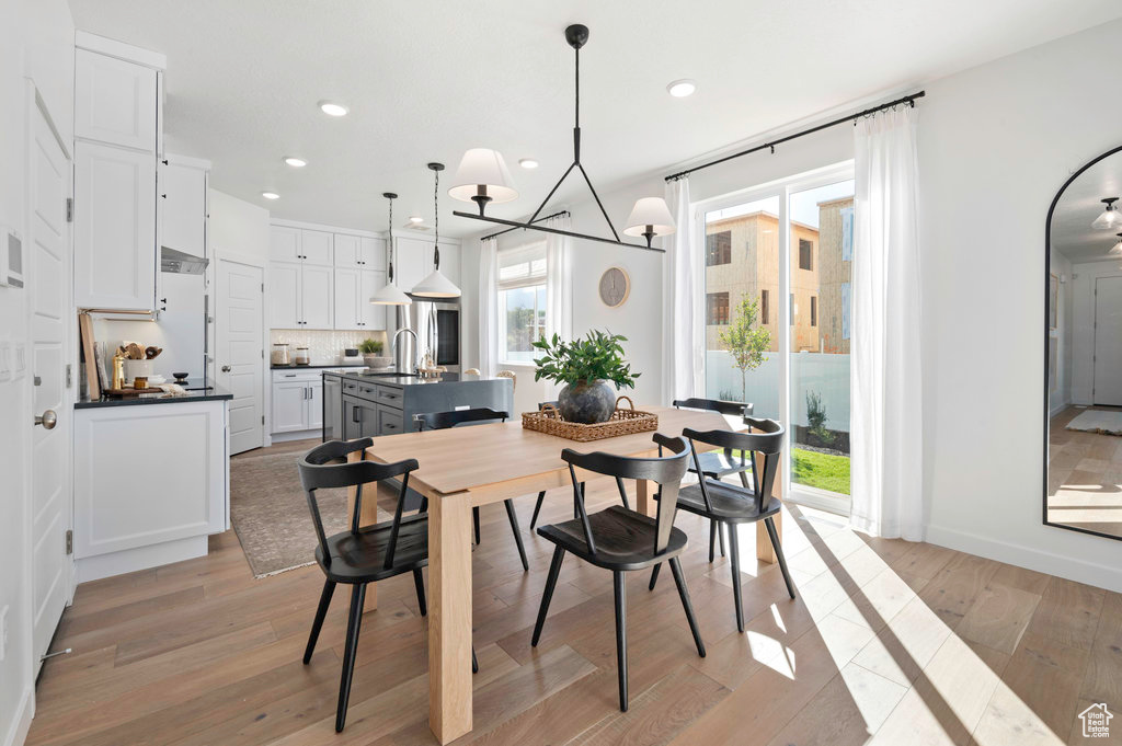 Dining space with recessed lighting and light wood finished floors
