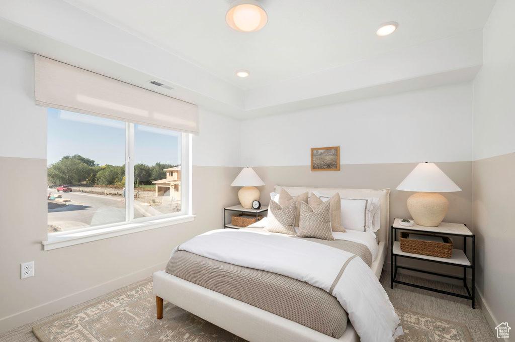 Bedroom featuring baseboards and visible vents