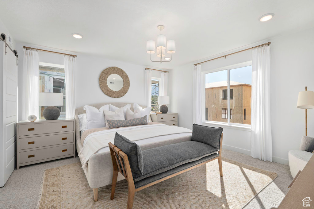 Bedroom with baseboards, recessed lighting, a barn door, and a chandelier
