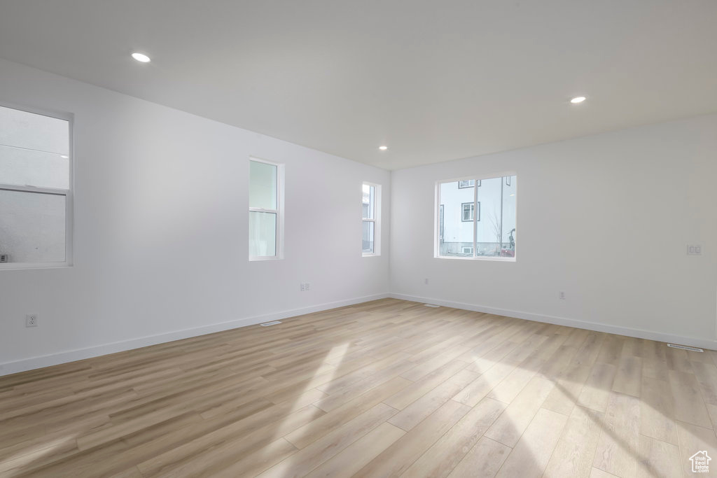 Spare room with recessed lighting, baseboards, and light wood-style flooring