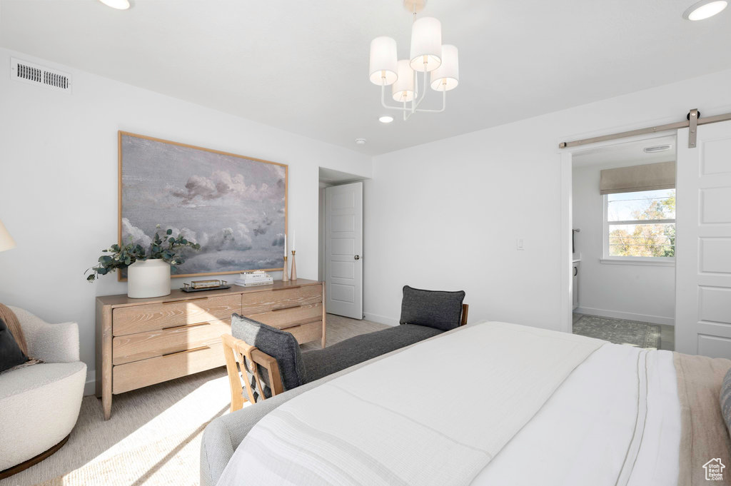 Bedroom featuring visible vents, baseboards, recessed lighting, a barn door, and a notable chandelier