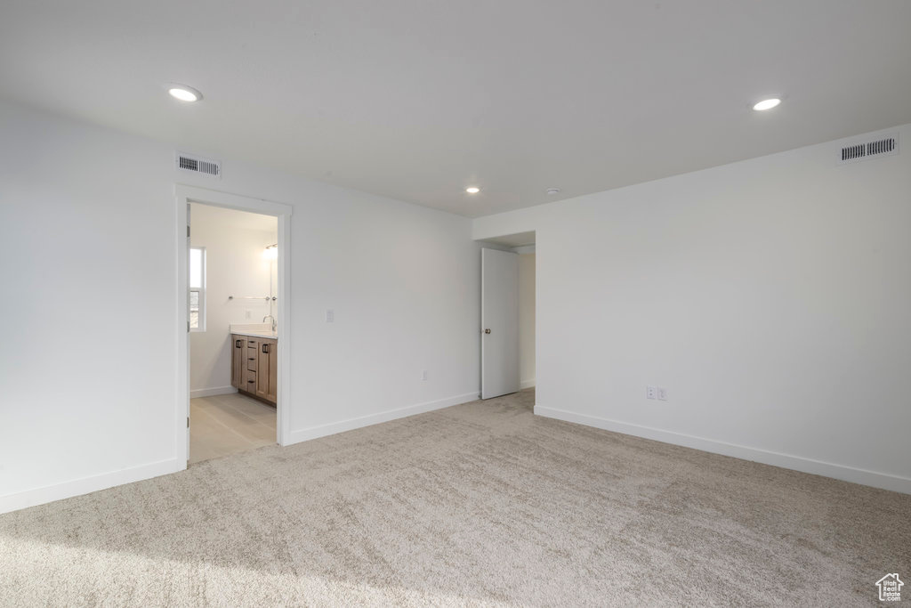 Spare room featuring light carpet, recessed lighting, and visible vents