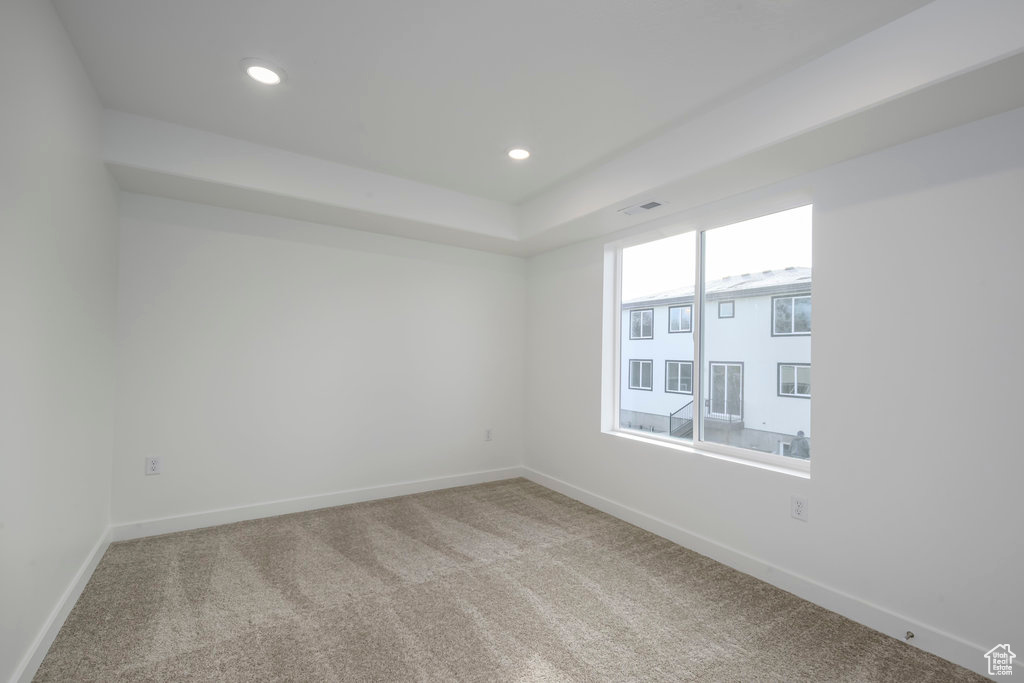 Empty room featuring baseboards, carpet flooring, and recessed lighting