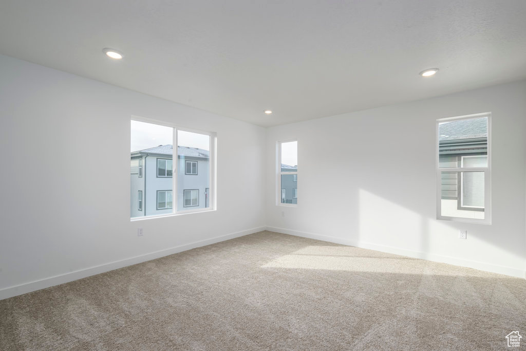 Spare room with baseboards, carpet, and recessed lighting