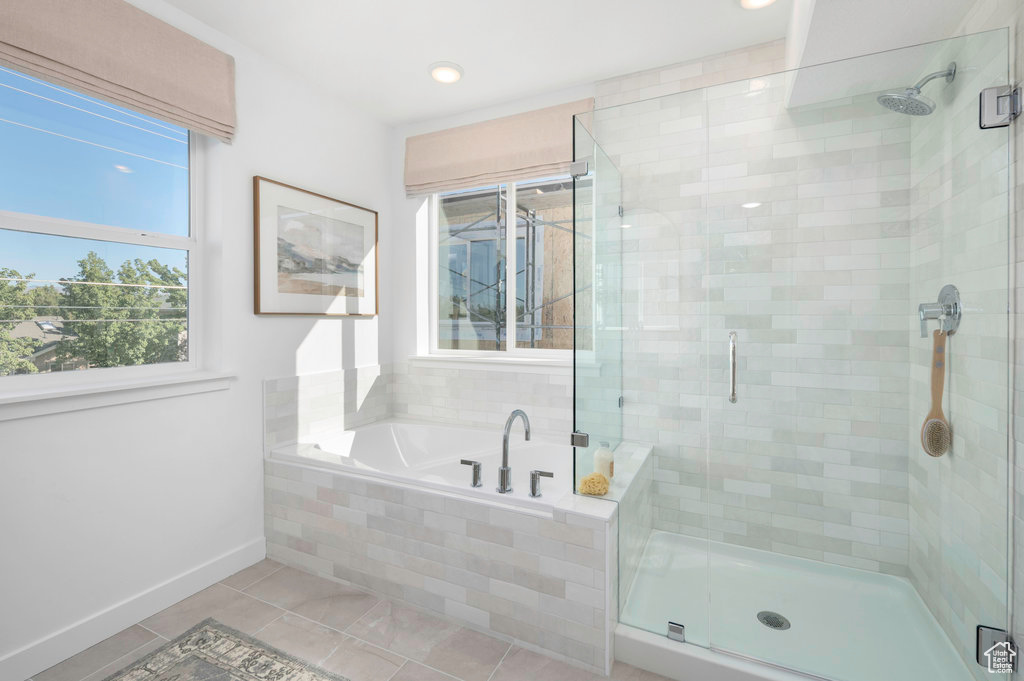 Bathroom with a garden tub, baseboards, recessed lighting, tile patterned floors, and a stall shower