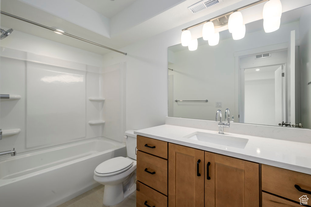 Bathroom featuring vanity, washtub / shower combination, toilet, and visible vents