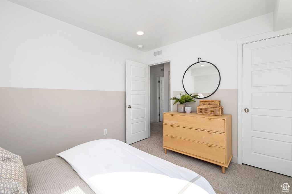 Bedroom with visible vents, recessed lighting, and light colored carpet