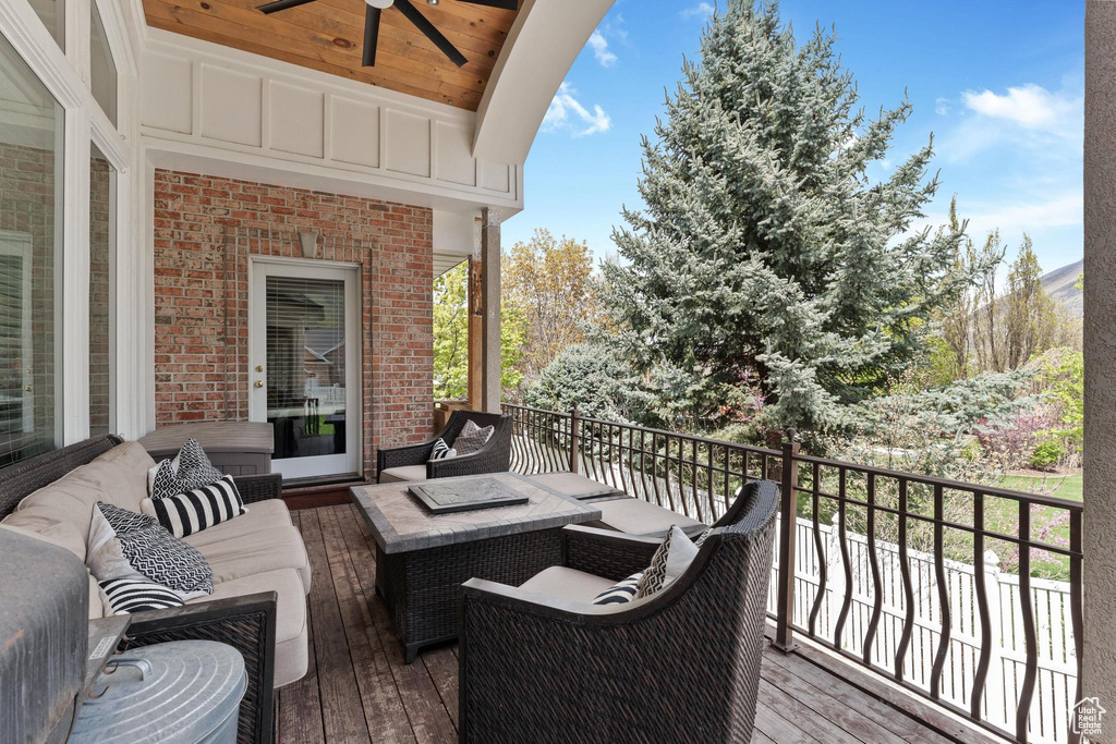 Deck with ceiling fan and an outdoor living space