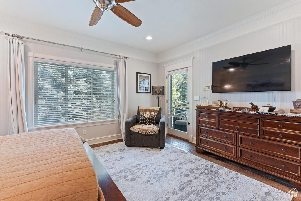 Bedroom featuring crown molding, access to outside, baseboards, and wood finished floors