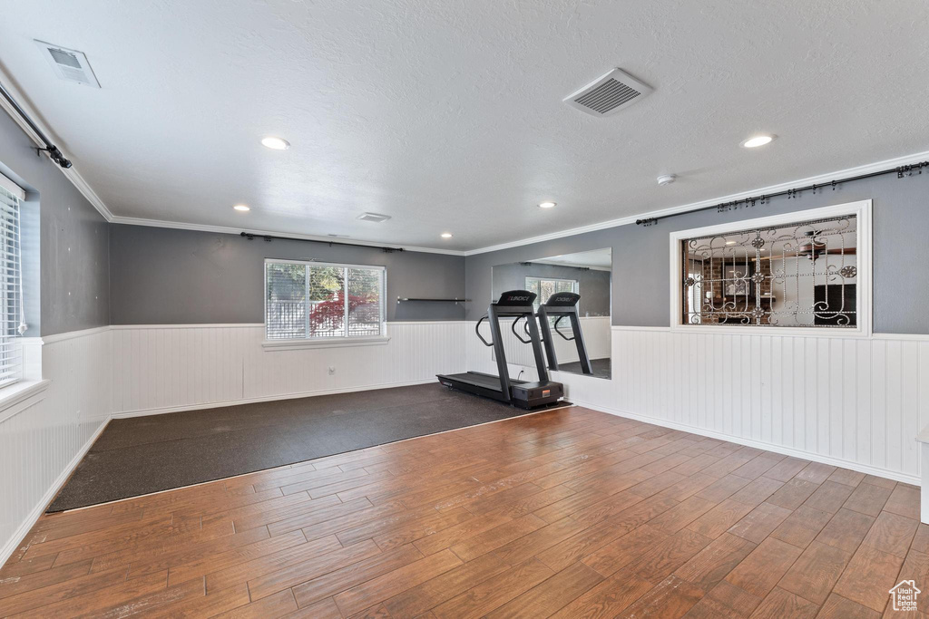 Workout area featuring visible vents, recessed lighting, a wainscoted wall, and wood finished floors