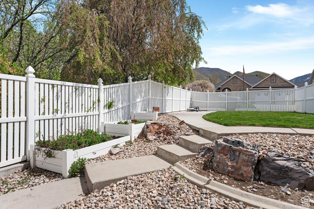 View of yard featuring a fenced backyard and a vegetable garden