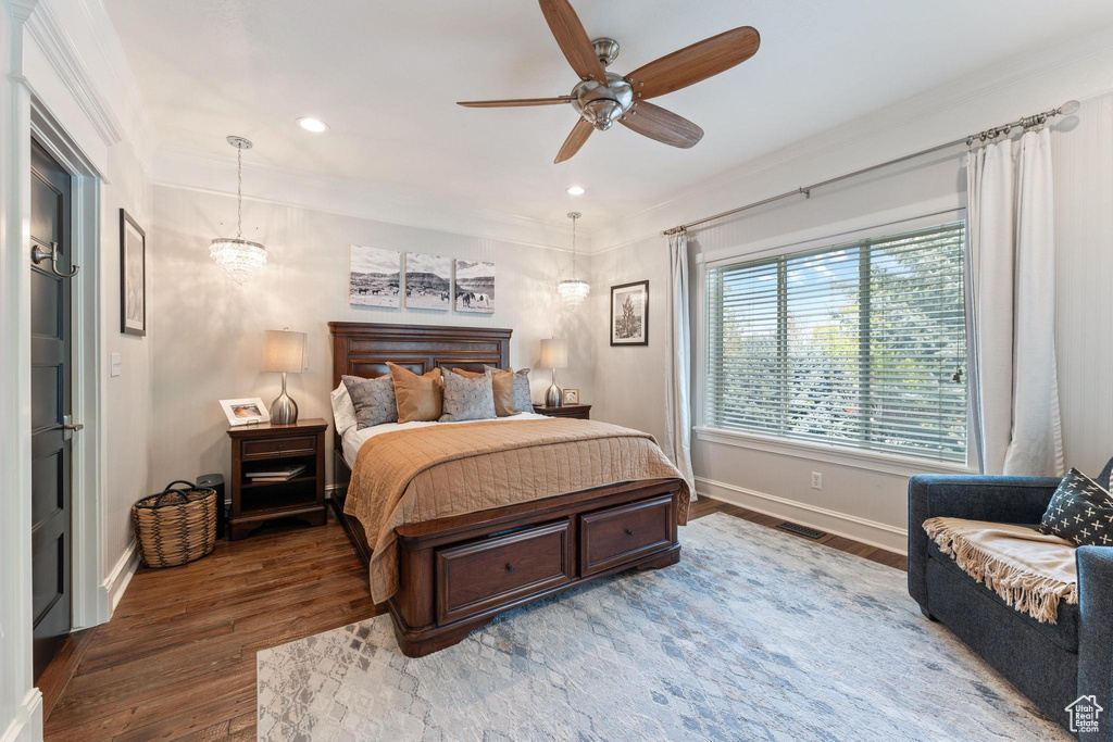 Bedroom with wood-type flooring, recessed lighting, baseboards, and crown molding