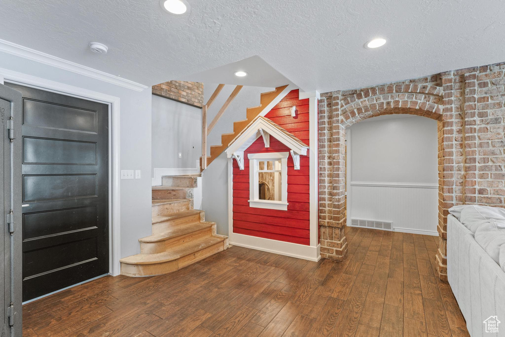 Foyer featuring visible vents, stairway, recessed lighting, a textured ceiling, and hardwood / wood-style flooring