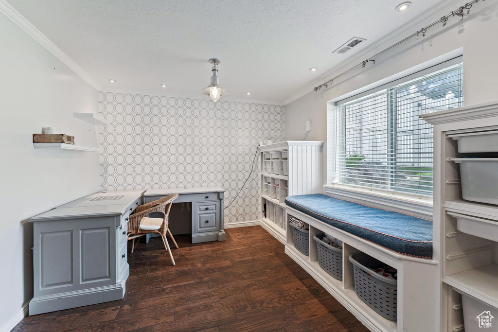 Home office featuring visible vents, ornamental molding, dark wood-style flooring, and wallpapered walls