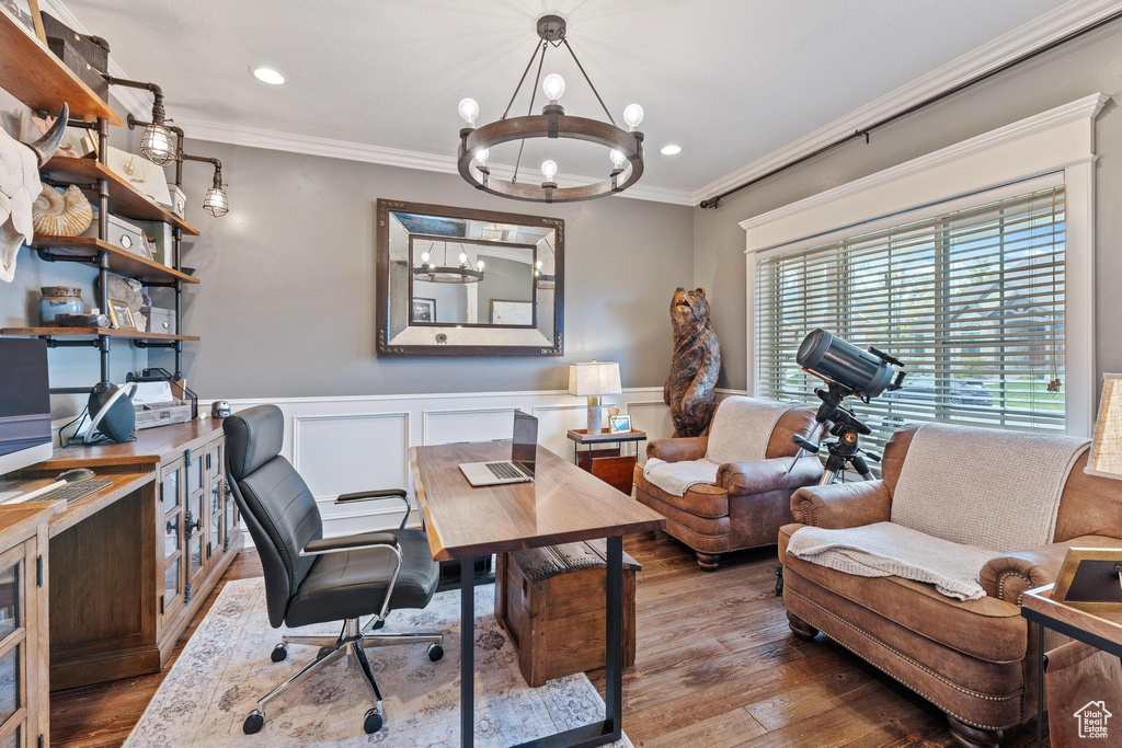 Office area featuring crown molding, an inviting chandelier, a wainscoted wall, and hardwood / wood-style floors