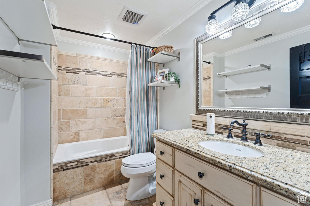 Bathroom featuring crown molding, decorative backsplash, toilet, and visible vents