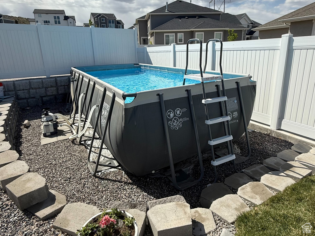 View of swimming pool with a fenced in pool and a fenced backyard