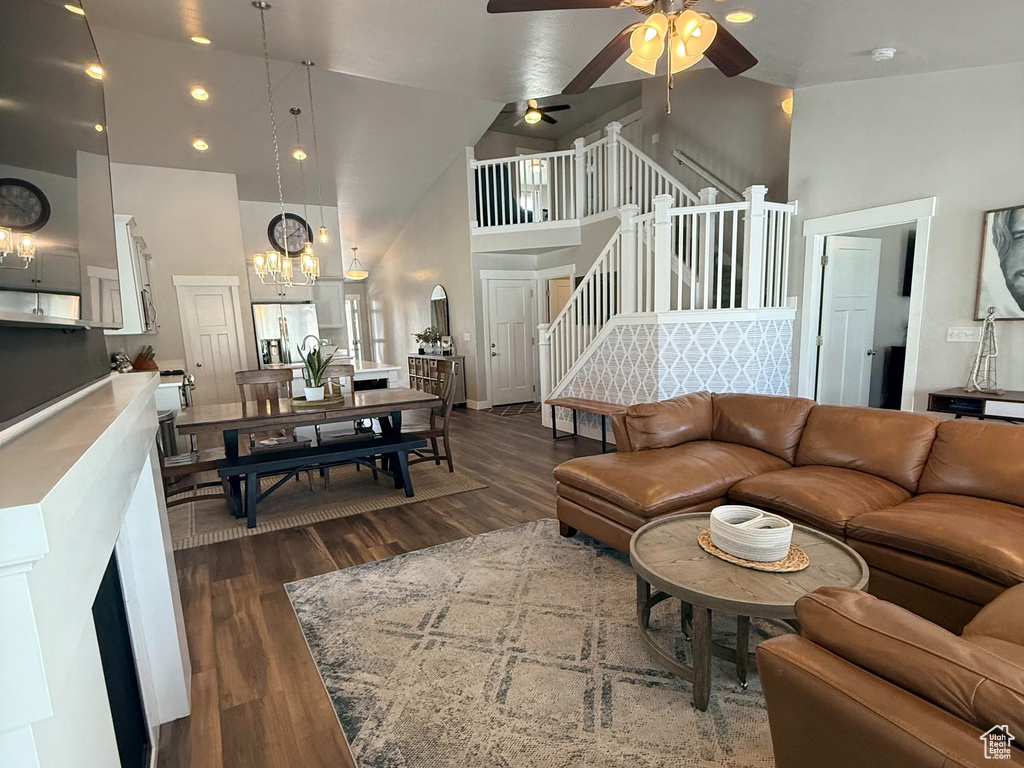 Living area with a ceiling fan, dark wood finished floors, and recessed lighting
