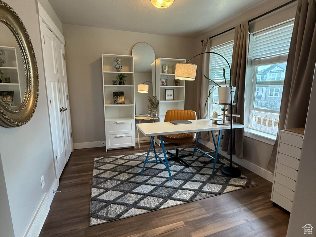 Home office with a textured ceiling, baseboards, and dark wood finished floors