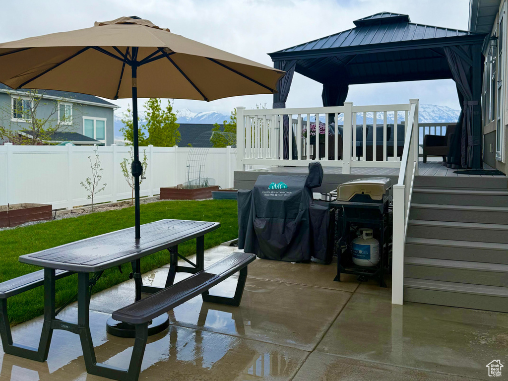 View of patio / terrace featuring fence, outdoor dining space, and a gazebo