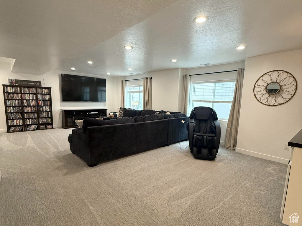 Living area with baseboards, carpet flooring, recessed lighting, and a textured ceiling