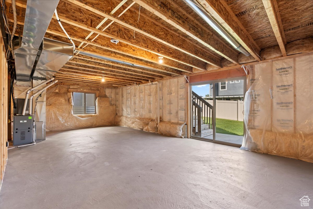 Basement featuring heating unit