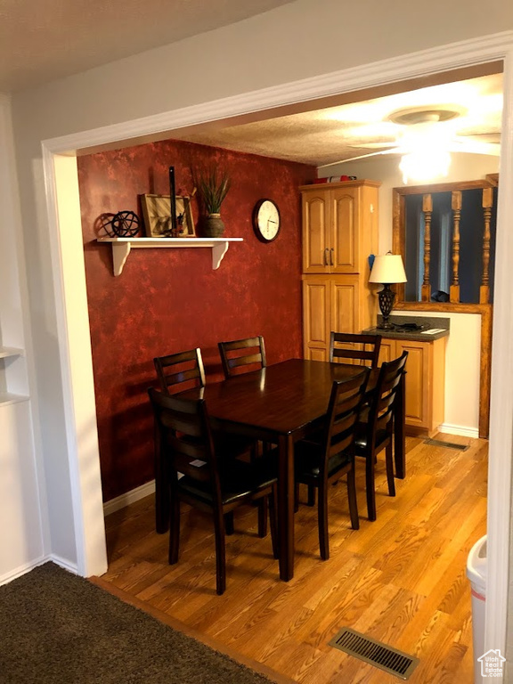 Dining area featuring baseboards, visible vents, and light wood-style floors