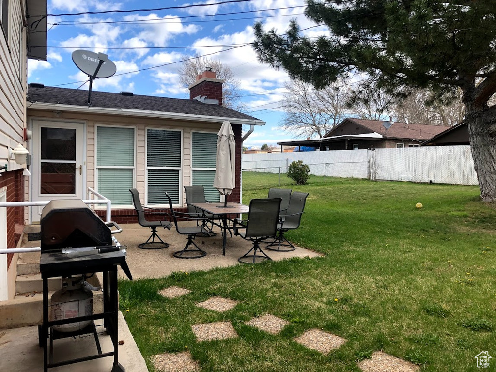 View of yard featuring a fenced backyard and a patio area