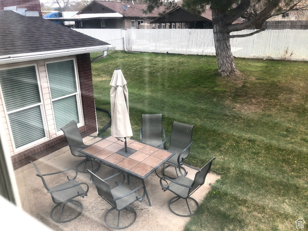 View of patio featuring fence and outdoor dining area