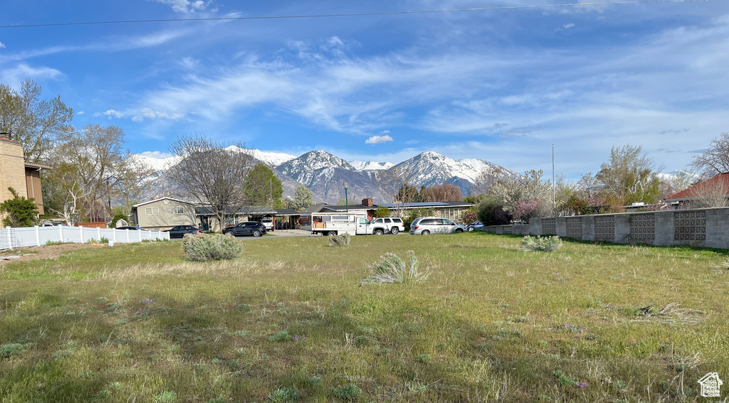 View of yard with fence and a mountain view