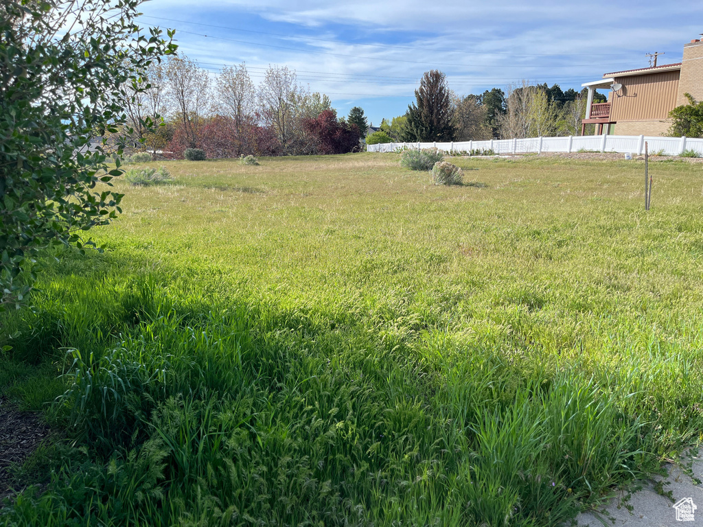 View of yard featuring fence