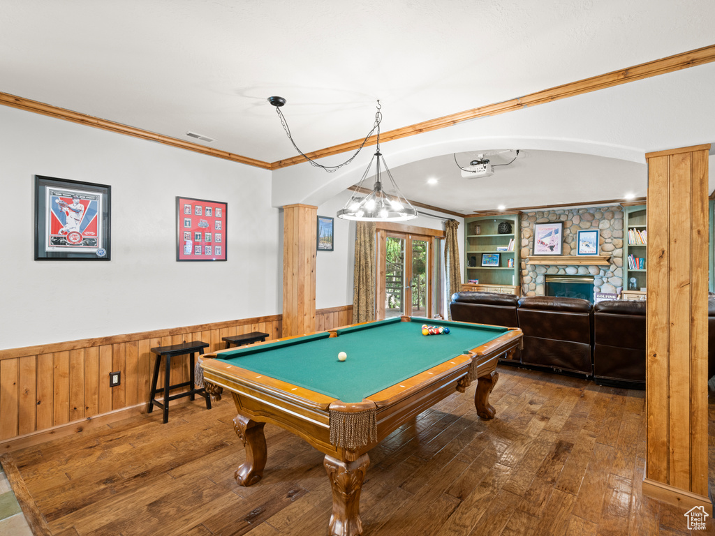 Playroom featuring crown molding, wood-type flooring, and wainscoting