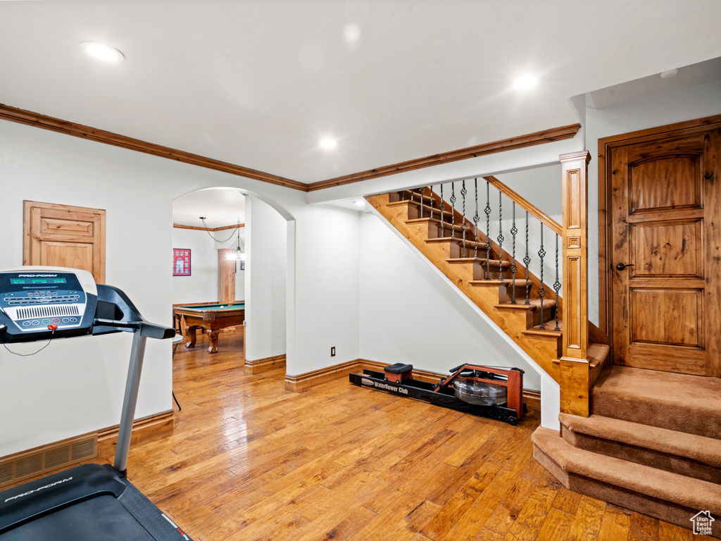 Workout room featuring ornamental molding, baseboards, recessed lighting, hardwood / wood-style flooring, and billiards
