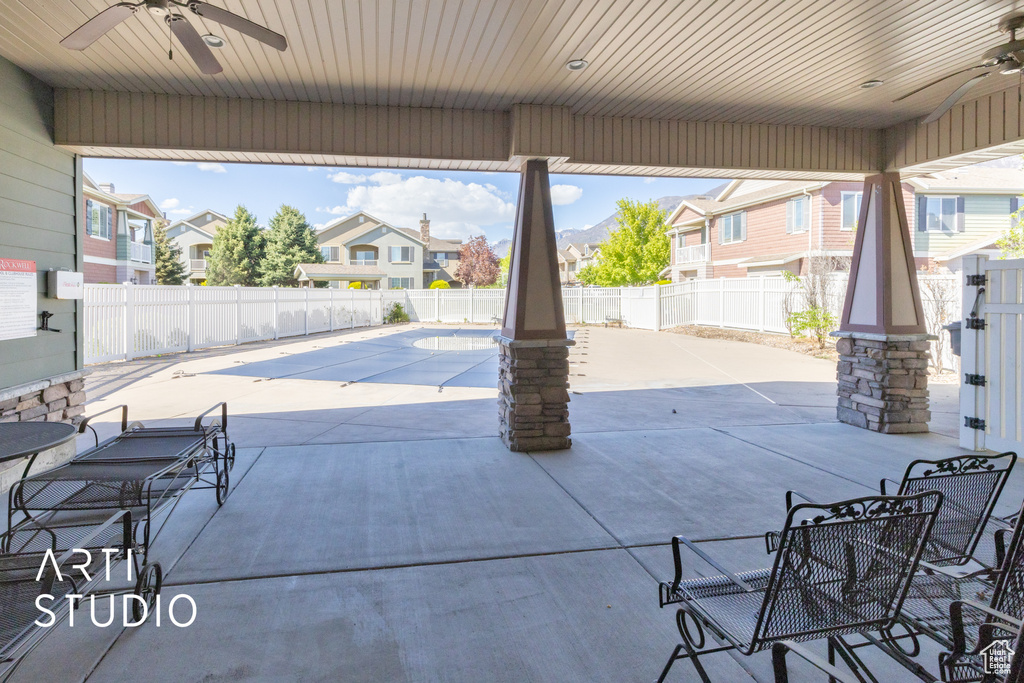 View of patio featuring a fenced in pool, a ceiling fan, a fenced backyard, and a residential view