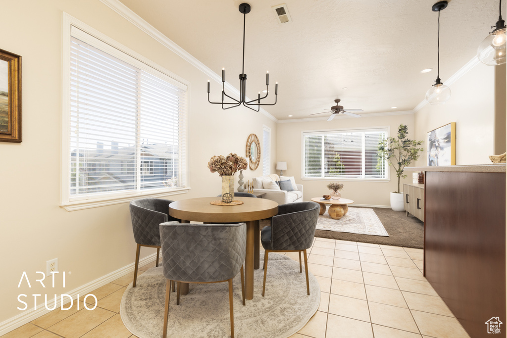 Dining room featuring visible vents, baseboards, crown molding, and light tile patterned floors