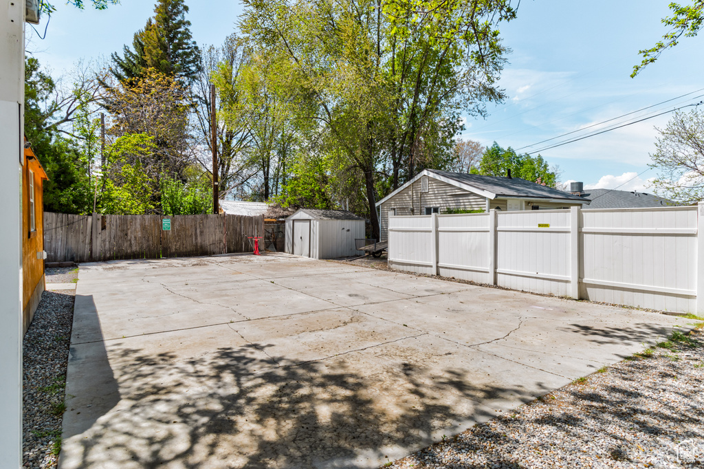 View of patio / terrace with an outdoor structure, a shed, and a fenced backyard