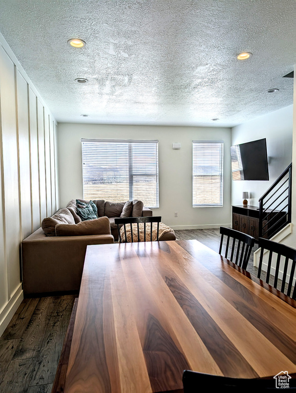 Dining area featuring recessed lighting, baseboards, dark wood-style floors, and a textured ceiling