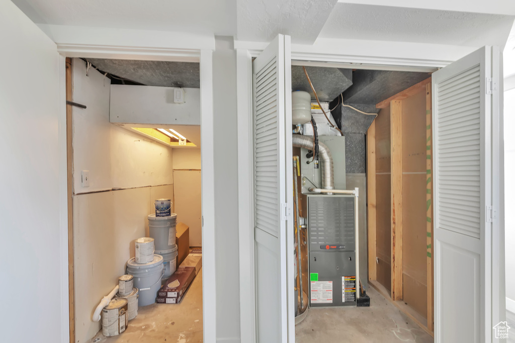Utility room featuring heating unit
