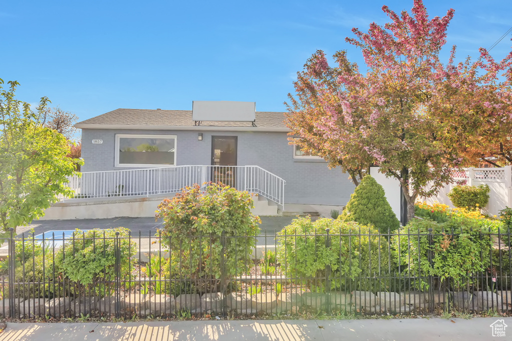 View of front of property featuring brick siding and fence private yard