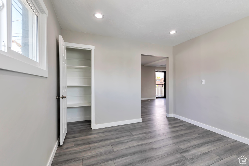 Unfurnished room featuring recessed lighting, baseboards, and wood finished floors