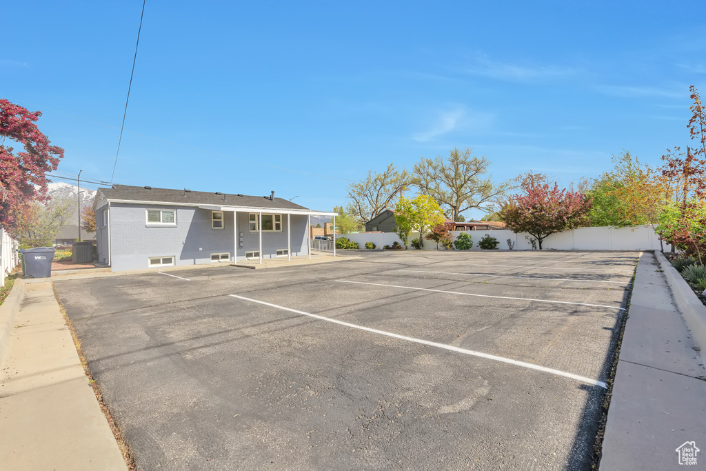 Uncovered parking lot featuring fence