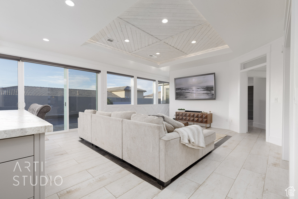 Living room featuring recessed lighting and a raised ceiling