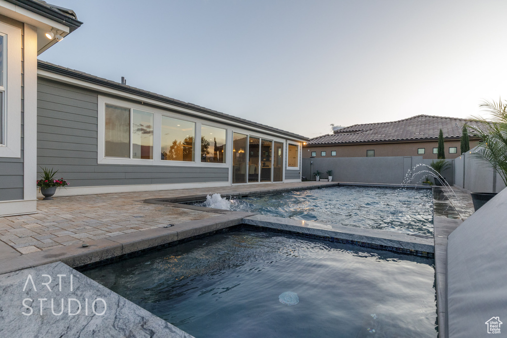 View of swimming pool with a fenced in pool, a fenced backyard, a patio area, and an in ground hot tub