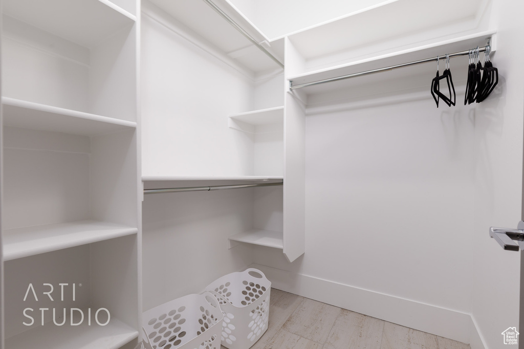 Spacious closet with wood finished floors