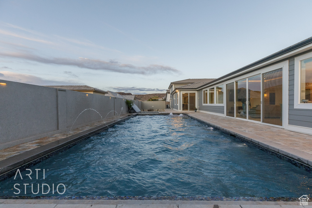 View of pool featuring a fenced in pool, a fenced backyard, and a patio area