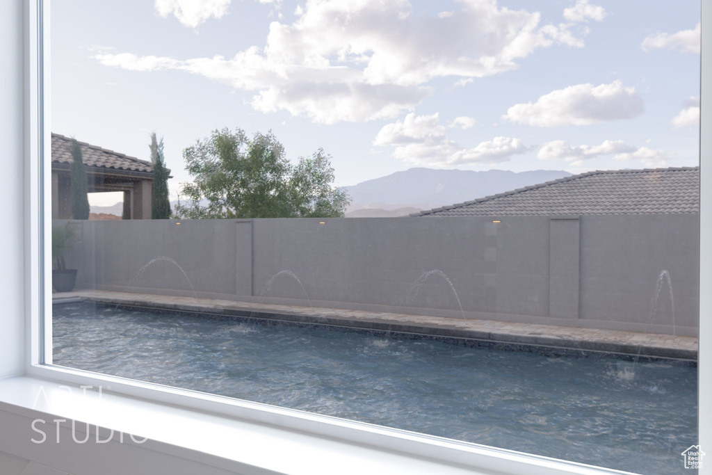 View of pool with a fenced in pool and a mountain view