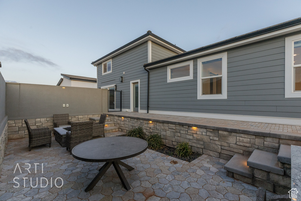 View of patio with outdoor lounge area and fence
